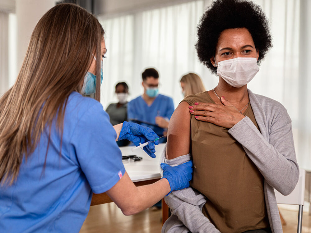 Healthcare worker administering a vaccine to a patient during flu season