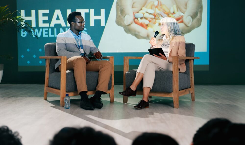 Health convention speaker discussing pathogen surveillance and public health